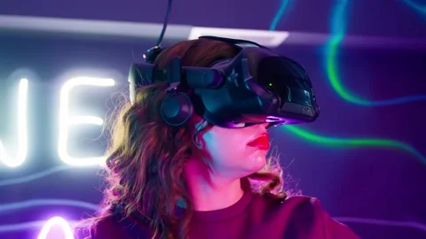 Cyber gamer in VR glasses plays virtual reality game in neon futuristic space. Stock Footage 238555553