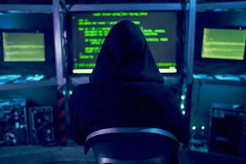 Cyber hacker breaks into databases to obtain information using a computer. Stock Photos