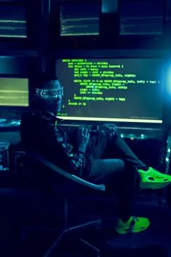 Cyber hacker breaks into databases to obtain information using a computer. 스톡 사진