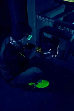 Cyber hacker breaks into databases to obtain information using a computer. Stock Photos