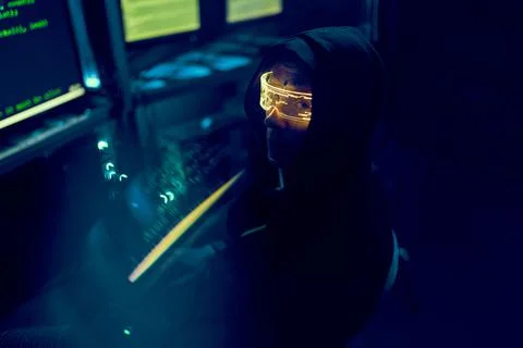 Cyber hacker breaks into databases to obtain information using a computer. Stock Photos