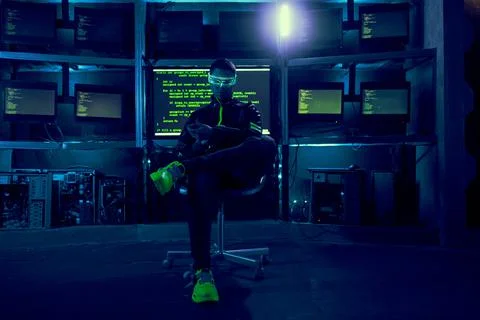 Cyber hacker breaks into databases to obtain information using a computer. 스톡 사진