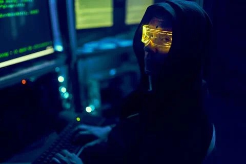 Cyber hacker breaks into databases to obtain information using a computer. Stock Photos