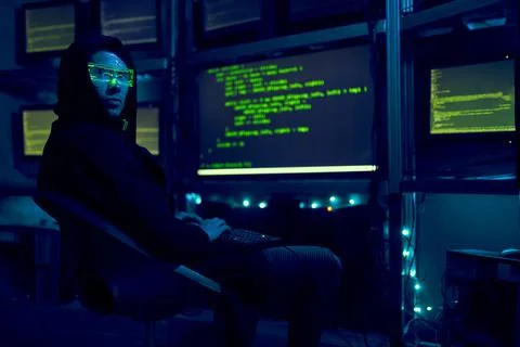 Cyber hacker breaks into databases to obtain information using a computer. Stock Photos