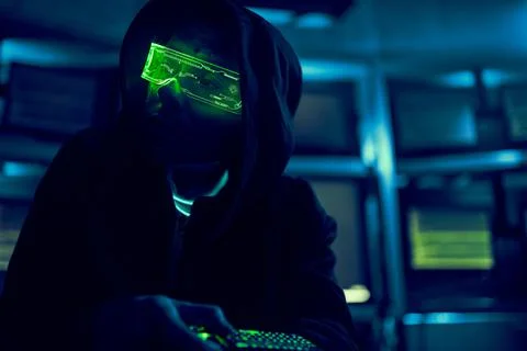 Cyber hacker breaks into databases to obtain information using a computer. Stock Photos