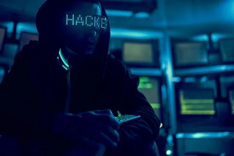 Cyber hacker breaks into databases to obtain information using a computer. Stock Photos