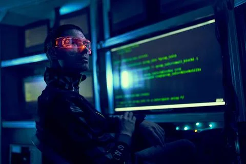 Cyber hacker breaks into databases to obtain information using a computer. Stock Photos