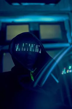 Cyber hacker breaks into databases to obtain information using a computer. Stock Photos