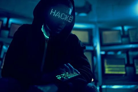 Cyber hacker breaks into databases to obtain information using a computer. 스톡 사진