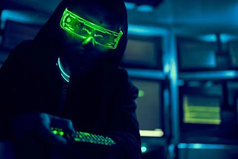 Cyber hacker breaks into databases to obtain information using a computer. 스톡 사진