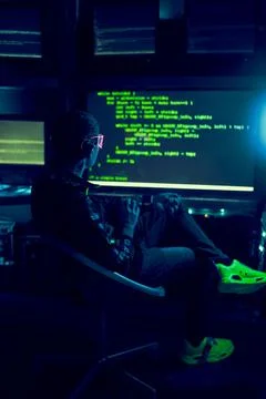 Cyber hacker breaks into databases to obtain information using a computer. 스톡 사진