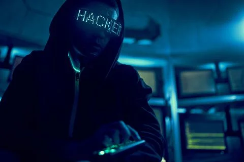 Cyber hacker breaks into databases to obtain information using a computer. Stock Photos