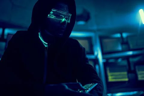 Cyber hacker breaks into databases to obtain information using a computer. Stock Photos