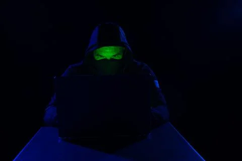 Cyber hacker, digital cyber security concept, hooded hacker behind laptop o.. Stockfoto's