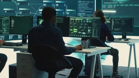 Cyber intelligence team of experts in a governmental hacking room Stock Photos