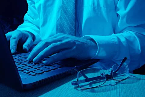 Cyber security analyst in blue light Stock Photos