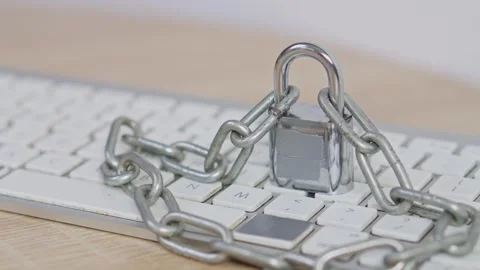 Cyber security concept Close-up of keyboard wrapped in heavy chains and locked Видео 328549974