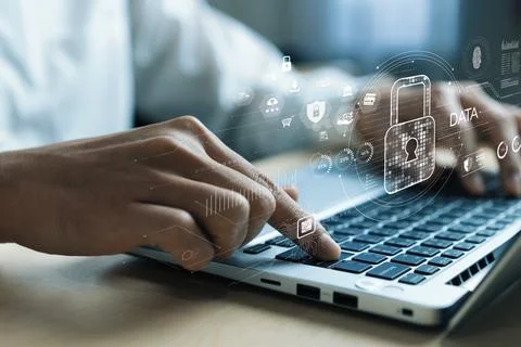 Cyber security concept with hands typing on laptop featuring digital padlock and Stock Photos