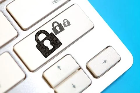 Cyber security concept. Padlock on the computer keyboard. Blue background Stock Photos