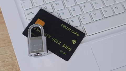 Cyber security concept with physical padlock on black credit card over white Stock Footage 328591986