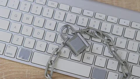 Cyber Security Concept Top view of silver padlock on keyboard representing Stock Footage 328549432