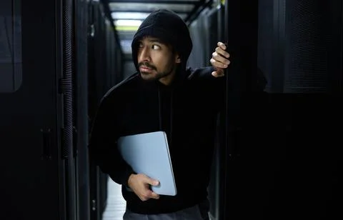 Cyber security, crime and hacker in server room with laptop in data center Foto stock