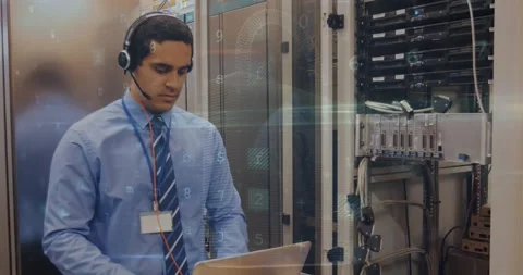 Cyber security data processing over male engineer with laptop working at server Stock Footage 329774839