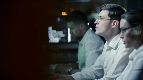 Cyber Security Team Working on Computers at Night Video stock 85827393