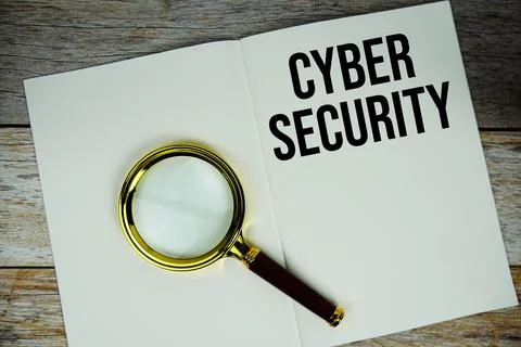 Cyber Security text message written on paper note with magnifying glass top.. Stockfoto's