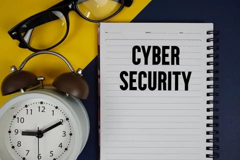 Cyber Security text written on notepad with alarm clock on blue background 스톡 사진