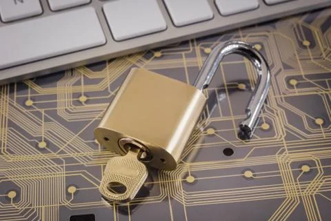 Cyber security with unlock key on circuit board. Stock Photos