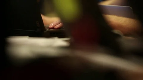 Cyber Tech  - Pan across table of laptops with Programmer's hand at work Stock Footage 74858234