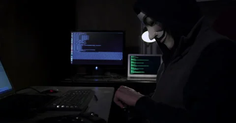 Cyber Terrorism - Anonymous Hacker with computer and gun Stock Footage 34394300