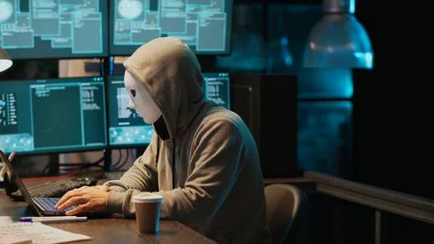 Cyber terrorist with mask hacking database servers Stock Photos