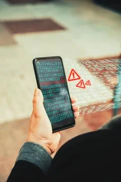 Cyberattack warning on smartphone screen. Stock Photos