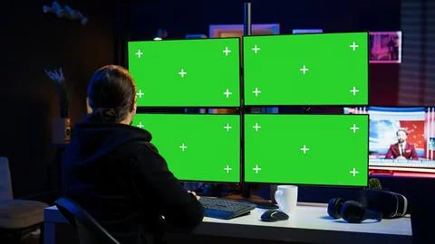 Cybercriminal coding on green screen monitors, developing zero day exploit Foto stock