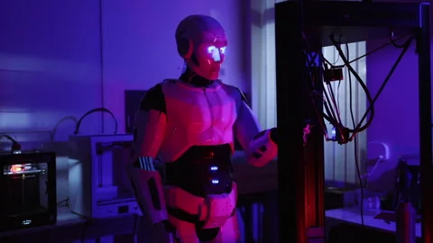 Cybernetic AI robot engineer fixing problems on 3d printer device interacting Stock Footage 153745511