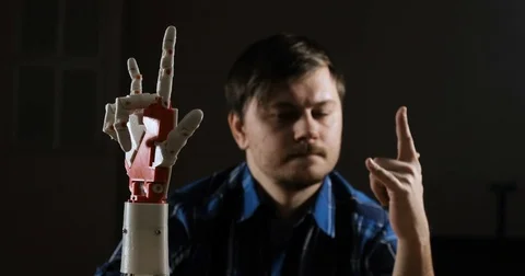 Cybernetic robot arm, which controls the people. Man controls robotic arm Stock Footage 85364946