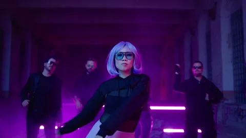 Cyberpunk: Asian model dancing at a shady lost place in front of a crowd 動画素材 280440537