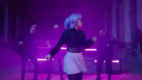 Cyberpunk: Asian model dancing at a shady lost place in front of a crowd Stock Footage 280440653
