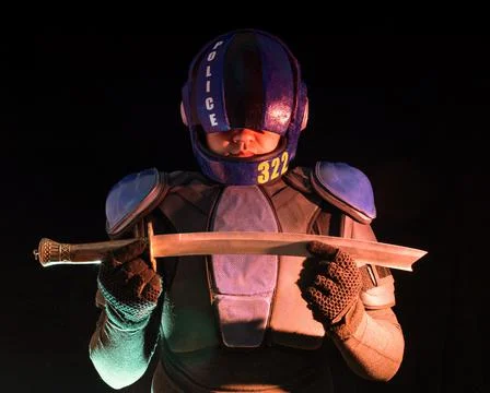 Cyberpunk future concept. Bionic cyborg police officer with short samurai sword Photos