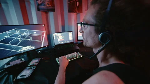 Cyberpunk hacker coding on multiple computers Stock Footage 341657133