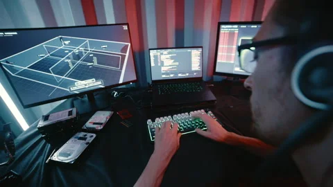 Cyberpunk hacker coding on multiple computers Stock Footage 341657221