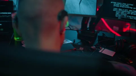 Cyberpunk Hacker Stealing Data on Computer in Neon Workspace Stock Footage 327632913