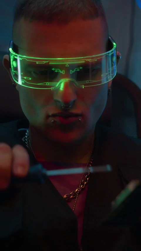 Cyberpunk Man in LED Visor Fixing Computer Detail in Dark Workspace Stock Footage 327632325