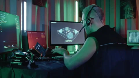 Cyberpunk Programmer Managing Multiple Screens in Industrial Container Stock Footage 341659405