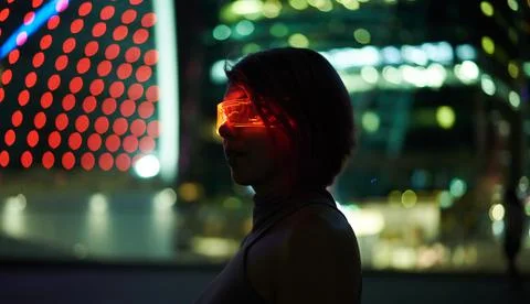 Cyberpunk style portrait of beautiful young woman in futuristic costume. Stock Photos