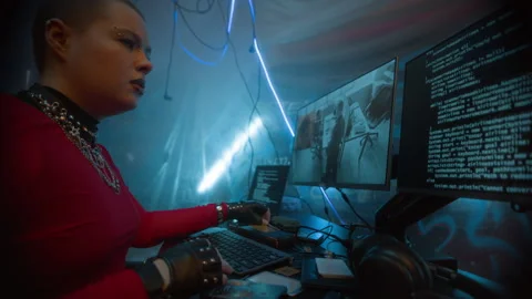 Cyberpunk Woman Hacking on Computer and Monitoring CCTV Footage in Neon Stock Footage 327636702