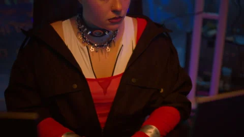 Cyberpunk Woman Hacking on Computer in Dark Neon Workspace Stock Footage 327635374