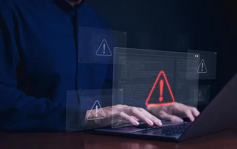 Cybersecurity alert concept. Person using laptop with multiple warning Foto stock